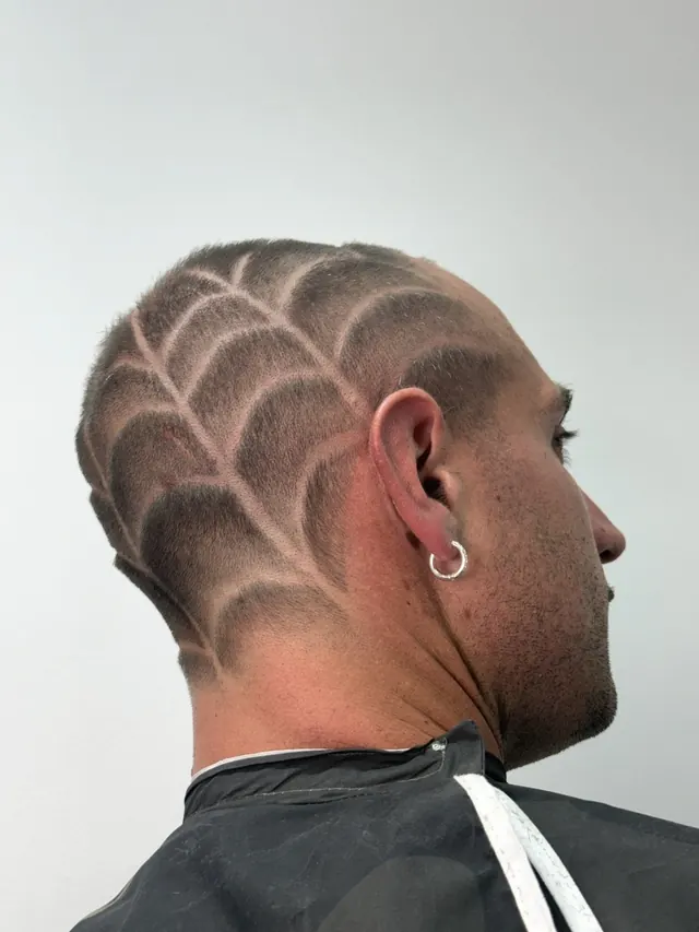 Skin fade taken to the skin and blended up, with a freehand razor pattern, Antisystem Barbershop, Bondi Beach